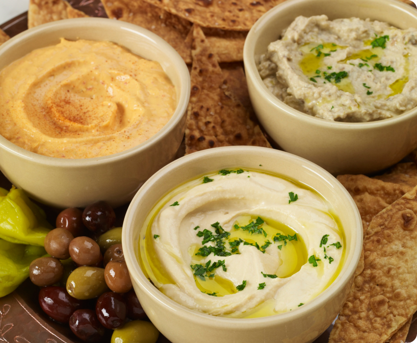 Portions of mashed potatoes, hummus, and rice