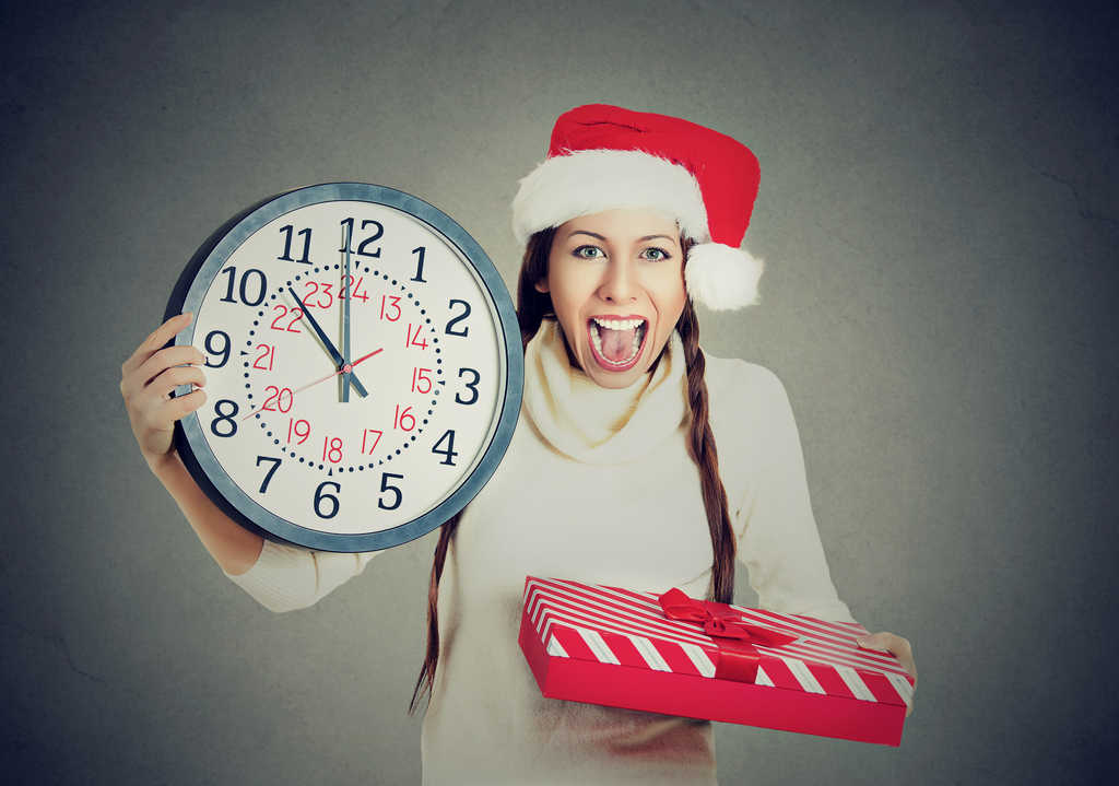 Woman holds up a clock because she's in a hurry. 